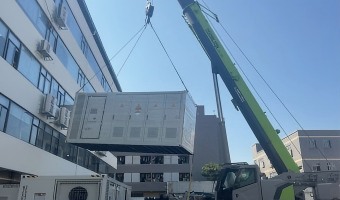 Crane installing containerised storage